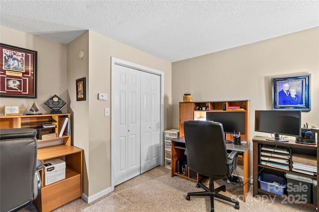 home office featuring light carpet and a textured ceiling