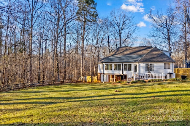 exterior space featuring a deck and a lawn