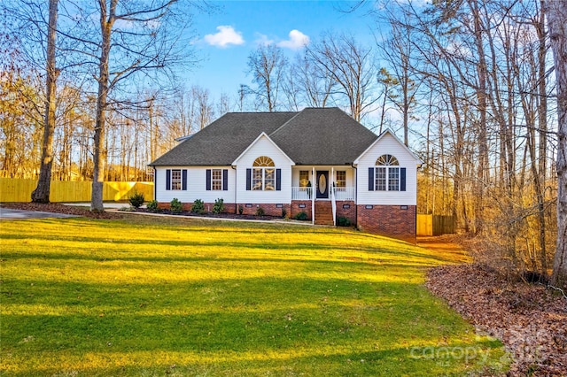 view of front of house with covered porch and a front lawn