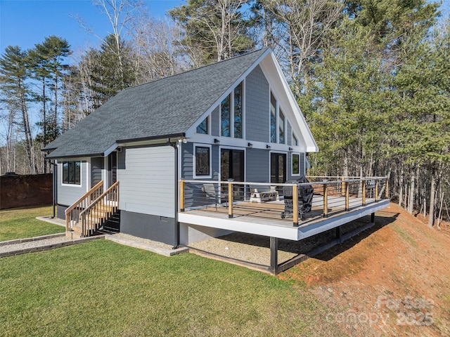 rear view of house featuring a lawn and a wooden deck