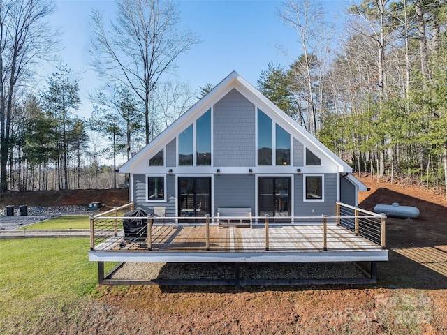 rear view of house featuring a yard and a wooden deck