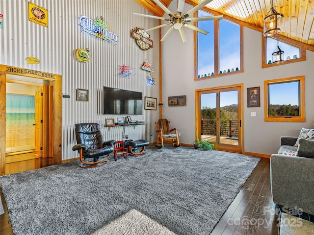 living room featuring ceiling fan, dark hardwood / wood-style floors, beam ceiling, and high vaulted ceiling