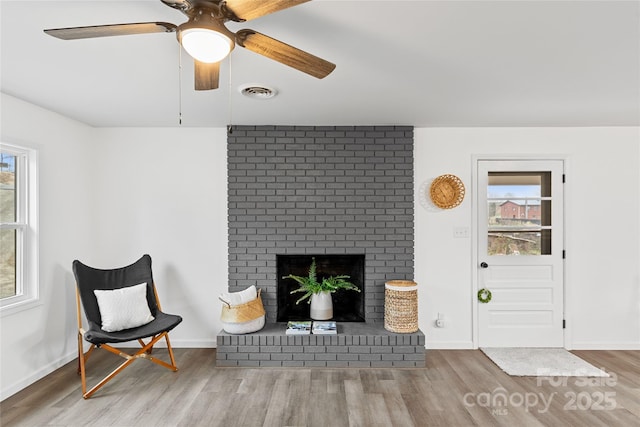 living room featuring hardwood / wood-style flooring and a fireplace