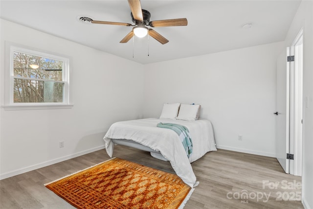 bedroom featuring ceiling fan and light hardwood / wood-style floors