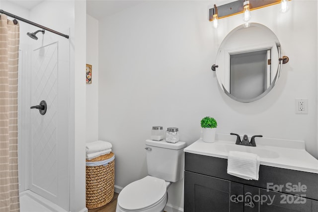 bathroom featuring vanity, curtained shower, and toilet