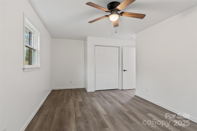 unfurnished bedroom featuring a closet, light hardwood / wood-style flooring, and ceiling fan