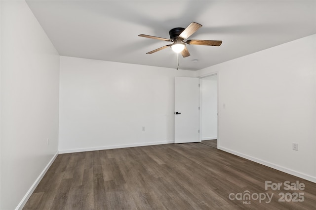 empty room featuring dark hardwood / wood-style floors and ceiling fan