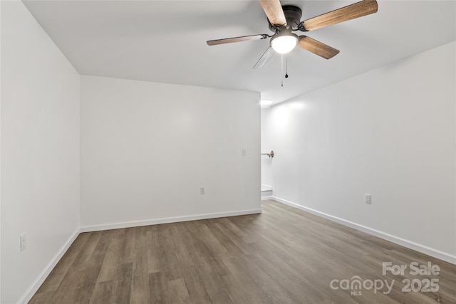 spare room with hardwood / wood-style flooring and ceiling fan