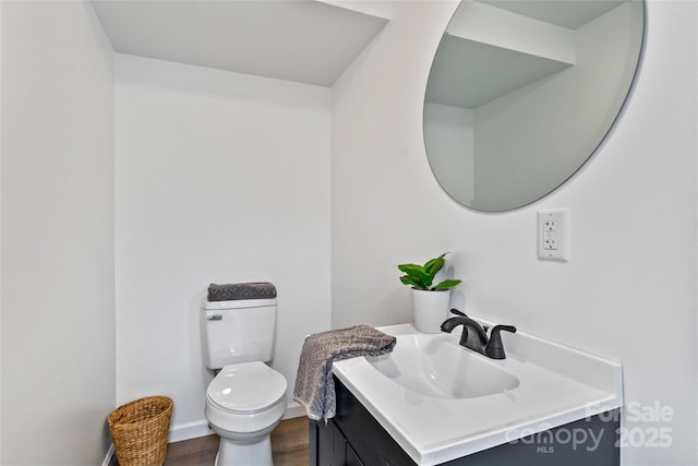 bathroom with vanity, toilet, and wood-type flooring