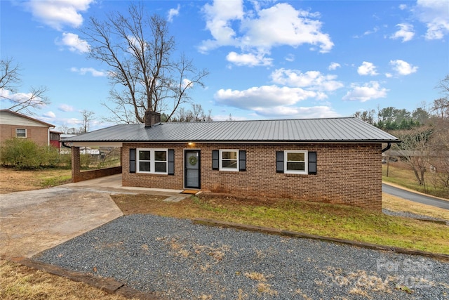 single story home featuring a carport