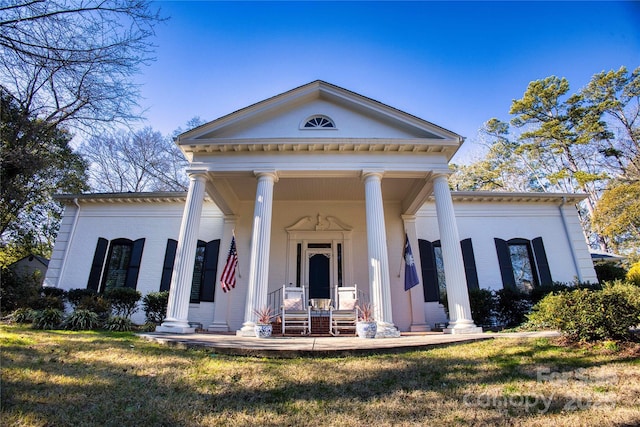 neoclassical / greek revival house with a front lawn