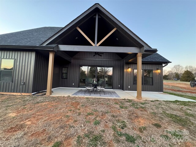 rear view of property featuring ceiling fan and a patio