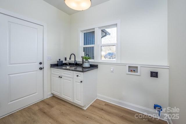 laundry area with washer hookup, sink, light hardwood / wood-style flooring, and electric dryer hookup