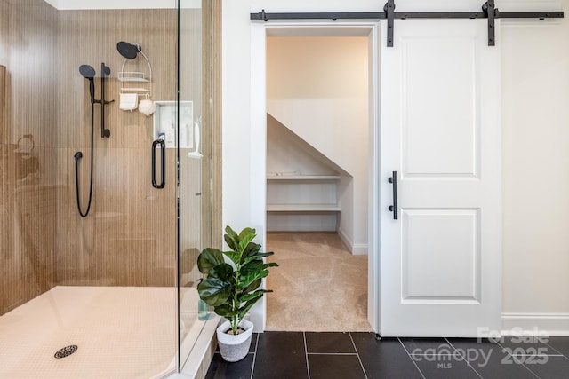 bathroom featuring a shower with door and tile patterned flooring