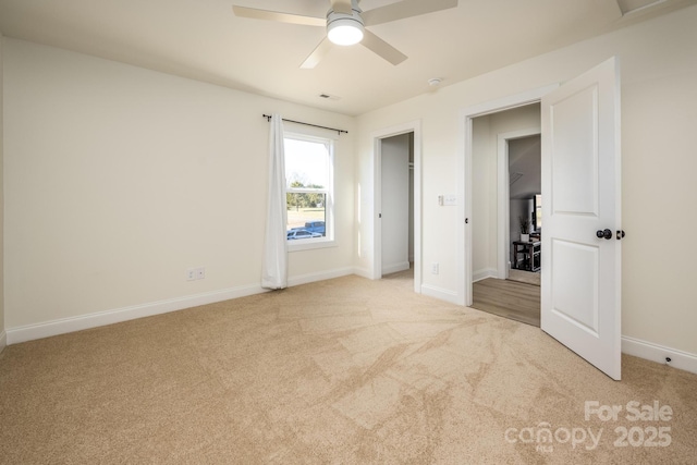 unfurnished bedroom featuring light colored carpet and ceiling fan