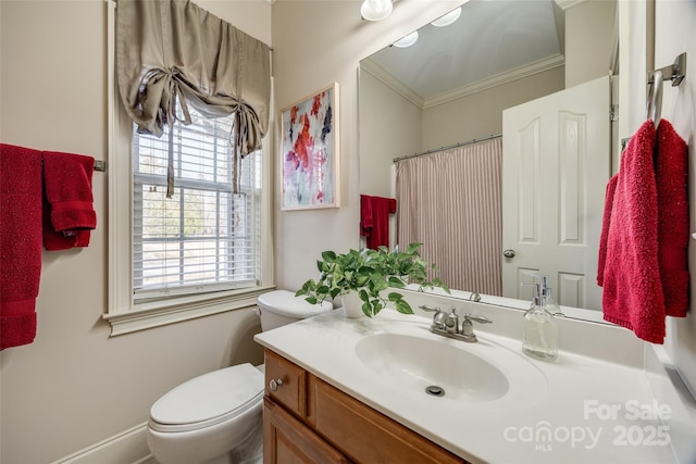 bathroom with ornamental molding, vanity, and toilet