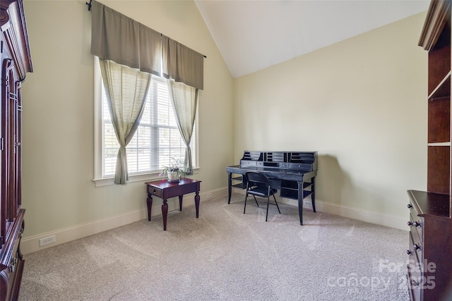 office space featuring lofted ceiling and light colored carpet