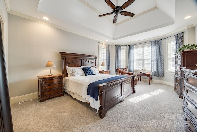 carpeted bedroom with ornamental molding, a raised ceiling, and ceiling fan