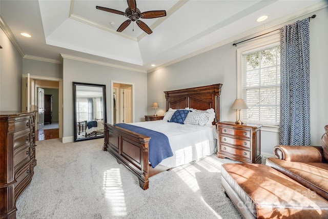 bedroom featuring ornamental molding, a raised ceiling, light carpet, and multiple windows