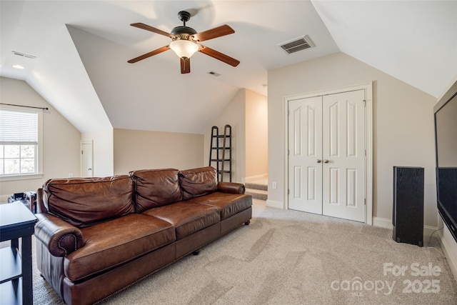 living room featuring vaulted ceiling, light colored carpet, and ceiling fan