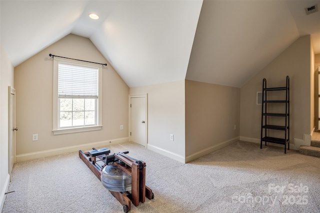 additional living space featuring lofted ceiling and light carpet