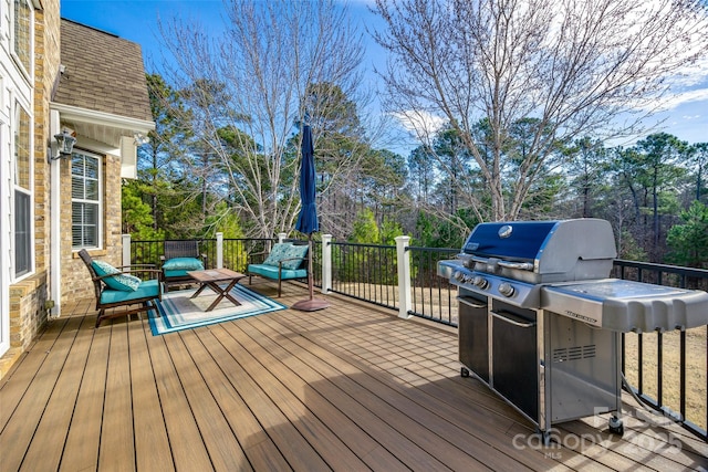 wooden deck with grilling area and outdoor lounge area