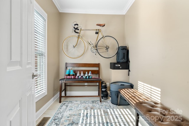 interior space with ornamental molding and light tile patterned floors