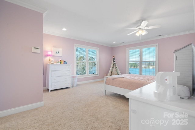 carpeted bedroom with multiple windows, ceiling fan, and ornamental molding