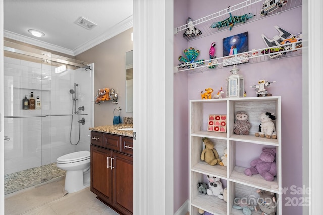 bathroom with vanity, a shower with door, crown molding, tile patterned flooring, and toilet