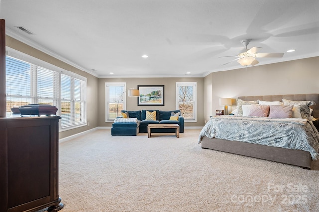 carpeted bedroom with ceiling fan and ornamental molding