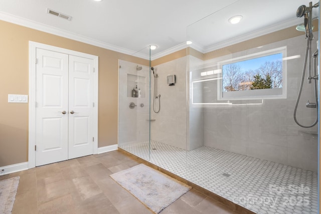 bathroom with crown molding and tiled shower