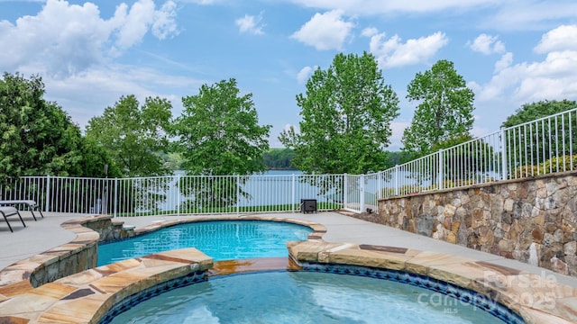 view of pool with a patio, an in ground hot tub, fence, and a fenced in pool