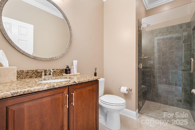bathroom with vanity, ornamental molding, toilet, baseboards, and a stall shower