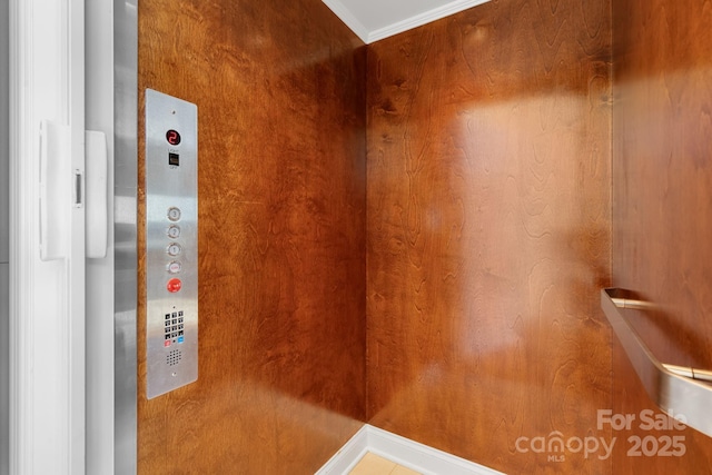 interior space featuring ornamental molding and elevator