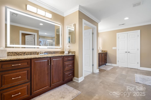 full bath featuring crown molding, vanity, baseboards, and visible vents