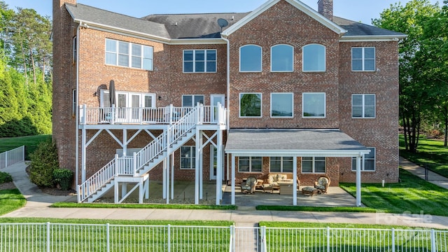 back of house featuring an outdoor living space, a fenced backyard, and a chimney