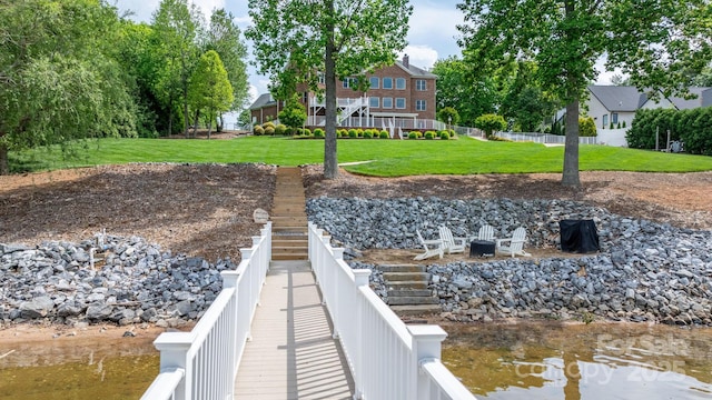 dock area featuring a yard and fence