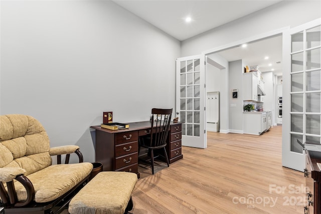 office space with french doors and light wood-type flooring