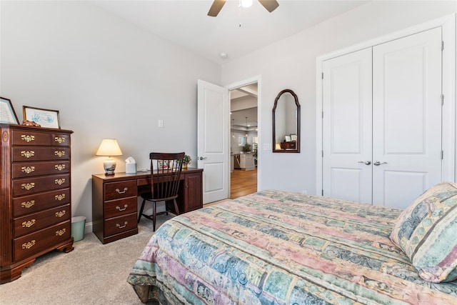 bedroom featuring ceiling fan, a closet, and light carpet