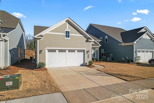 front of property with cooling unit and a garage