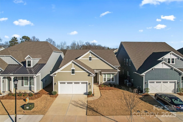 view of front of home featuring central AC and a garage