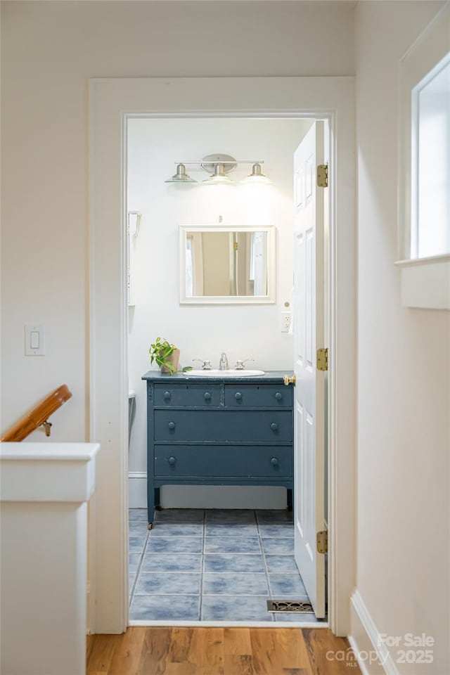 bathroom featuring hardwood / wood-style flooring and vanity