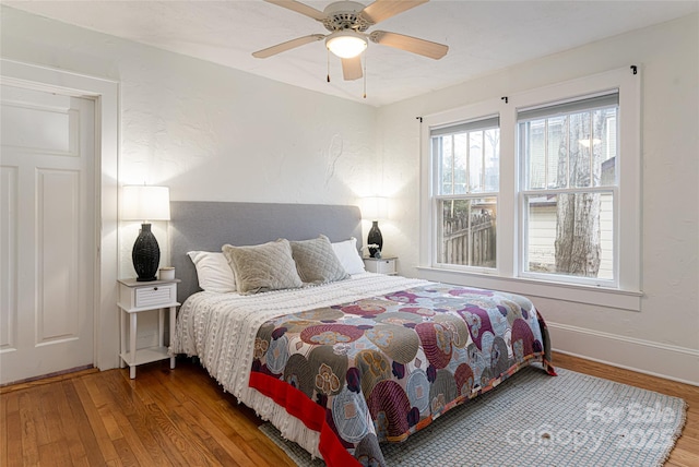 bedroom with ceiling fan and wood-type flooring