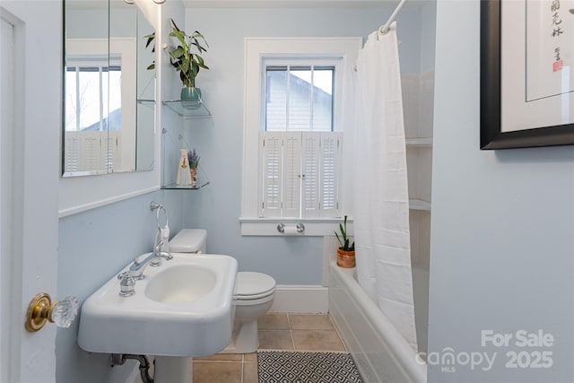 full bathroom with shower / bath combo with shower curtain, sink, toilet, and tile patterned flooring