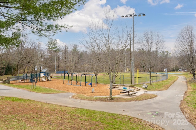 surrounding community featuring a playground and a yard