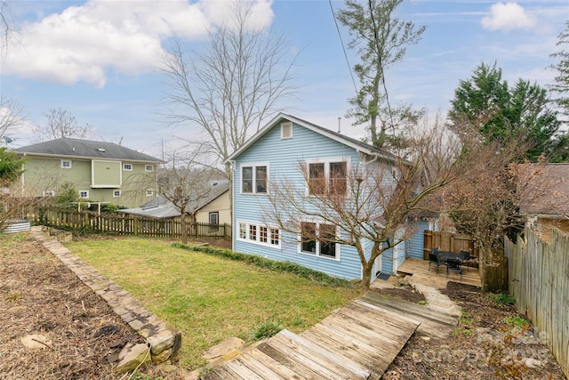 rear view of property featuring a yard