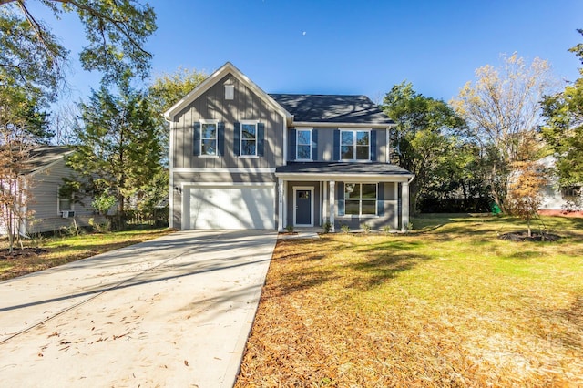 view of front of home featuring a front yard and a garage