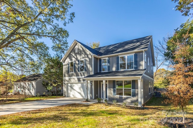 view of front facade with central AC unit, a front yard, and a garage