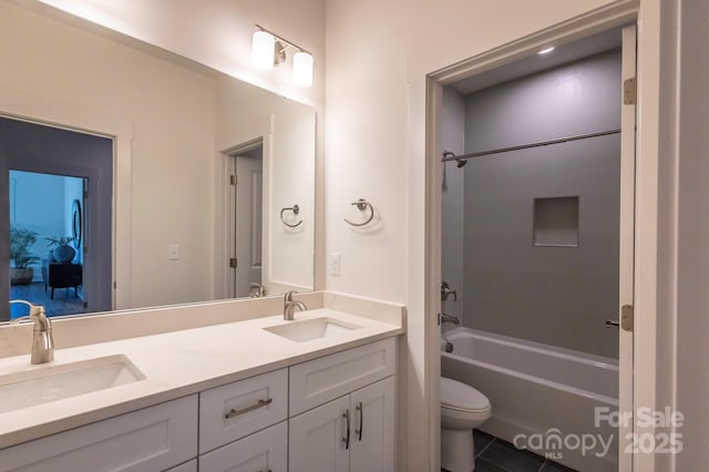 full bathroom with tile patterned flooring, shower / tub combination, vanity, and toilet