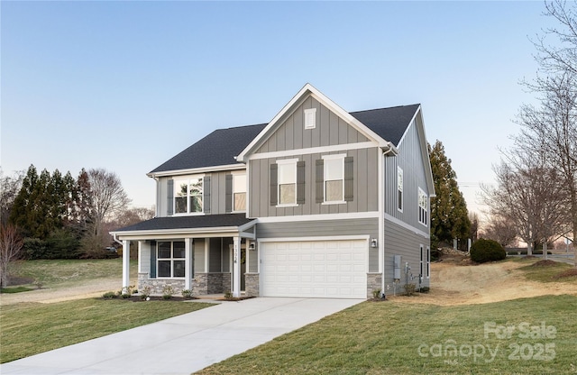 view of front of house featuring driveway, stone siding, board and batten siding, and a front yard